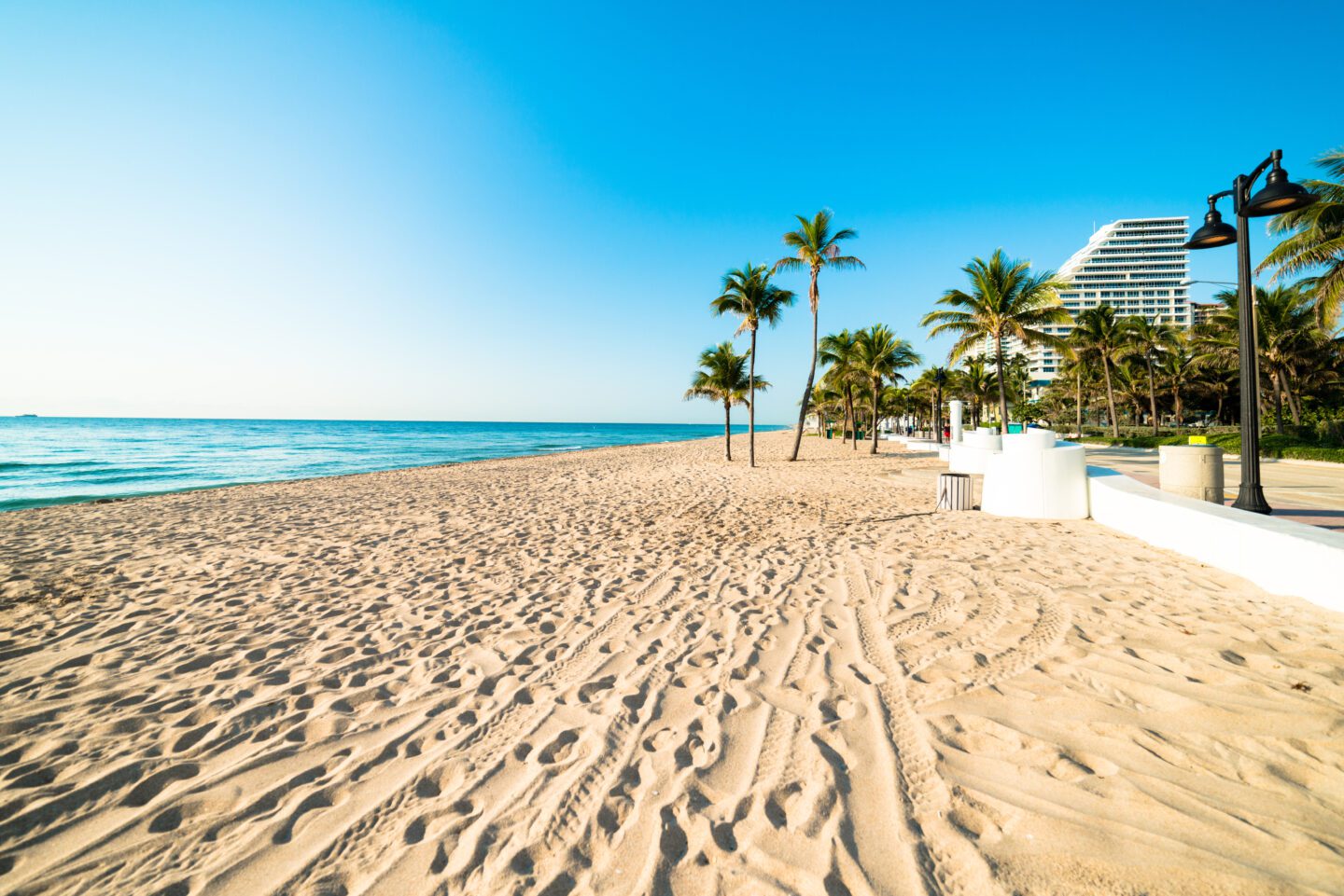 White sand deserted Clearwater Beach South Florida beach stretching out under beautiful blue cloudless sky